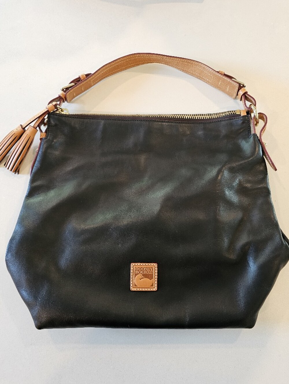 Dooney & Bourke Black Leather Shoulder Bag with Tan Trim and Tassel